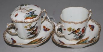 A pair of 'Augustus Rex' cups and saucers (one lid)