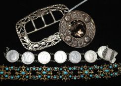 A silver buckle by William Comyns, a Scottish silver brooch and two bracelets.