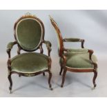 A pair of Victorian rosewood armchairs, with brass ribbon crests, on cabriole legs and wooden