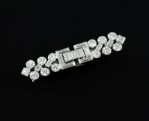 A mid 20th century Cartier platinum and diamond bar brooch, set with round, square and baguette