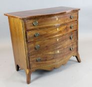 A George III inlaid mahogany serpentine chest, of four graduated long drawers, on swept bracket