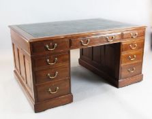 A late Victorian mahogany partner's desk, by Maples, fitted nine drawers and two panelled cupboards,