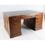 A late Victorian mahogany partner's desk, by Maples, fitted nine drawers and two panelled cupboards,