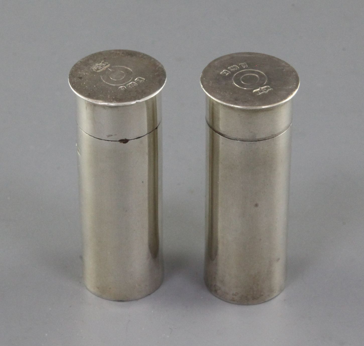 A pair of 1930's novelty silver condiments modelled as shotgun cartridges, by Mappin & Webb,