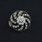 A Victorian gold, silver and diamond circular brooch, with pierced spiral decoration and set with