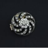 A Victorian gold, silver and diamond circular brooch, with pierced spiral decoration and set with