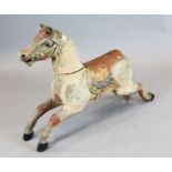 An early 20th century carved and painted wood carousel horse, with glass eyes, W.39in. H.27in.