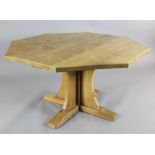 A Robert 'Mouseman' Thompson oak octagonal centre table, with saltire pillar and trestle feet, a