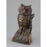 A late 19th century cast iron owl money bank, c.1880, with original painted finish, glass inset eyes