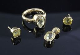 An 18ct gold and yellow sapphire set suite of jewellery, comprising a solitaire ring, pendant and