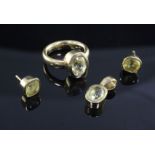 An 18ct gold and yellow sapphire set suite of jewellery, comprising a solitaire ring, pendant and