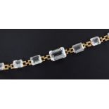 A Brazilian gold and aquamarine set bracelet, mounted with seven graduated stones, 6.5in.