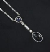 A white gold, cabochon sapphire and diamond set drop pendant necklace, the two sapphire with a total