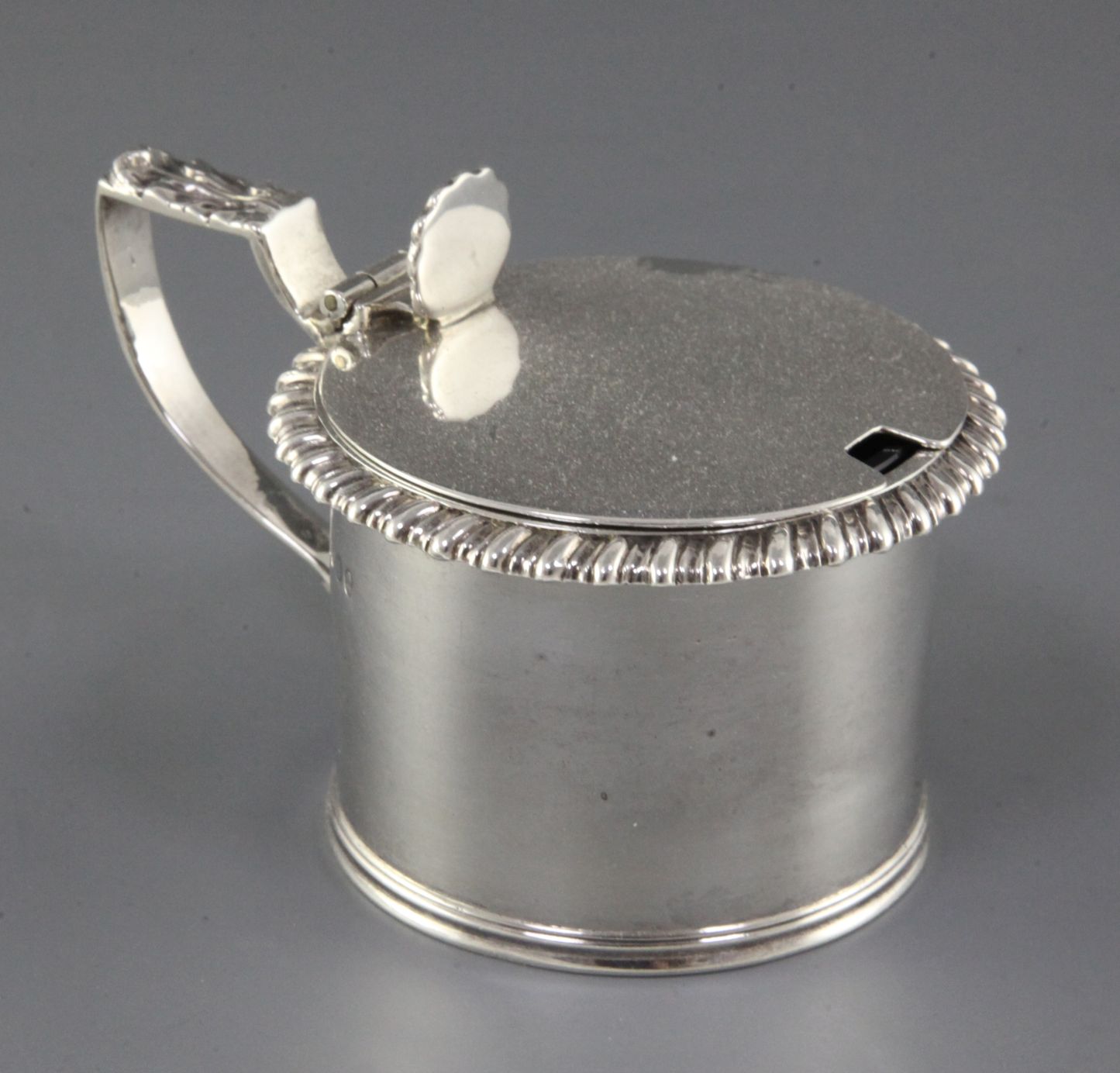 A George IV silver drum mustard by Emes & Barnard, with gadrooned border, shell thumbpiece and