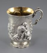 A Victorian silver christening mug embossed with a child and seated dog, James Charles Edington,