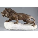 Bartelier. An Art Deco bronze figure of a lion, standing upon a naturalistic white marble plinth,