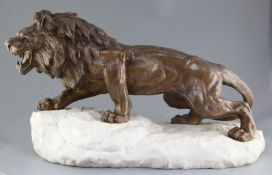 Bartelier. An Art Deco bronze figure of a lion, standing upon a naturalistic white marble plinth,