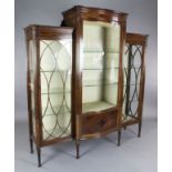 An Edwardian Sheraton Revival inlaid mahogany serpentine display cabinet, with astragal glazed doors