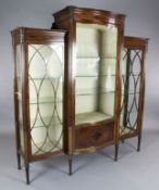 An Edwardian Sheraton Revival inlaid mahogany serpentine display cabinet, with astragal glazed doors