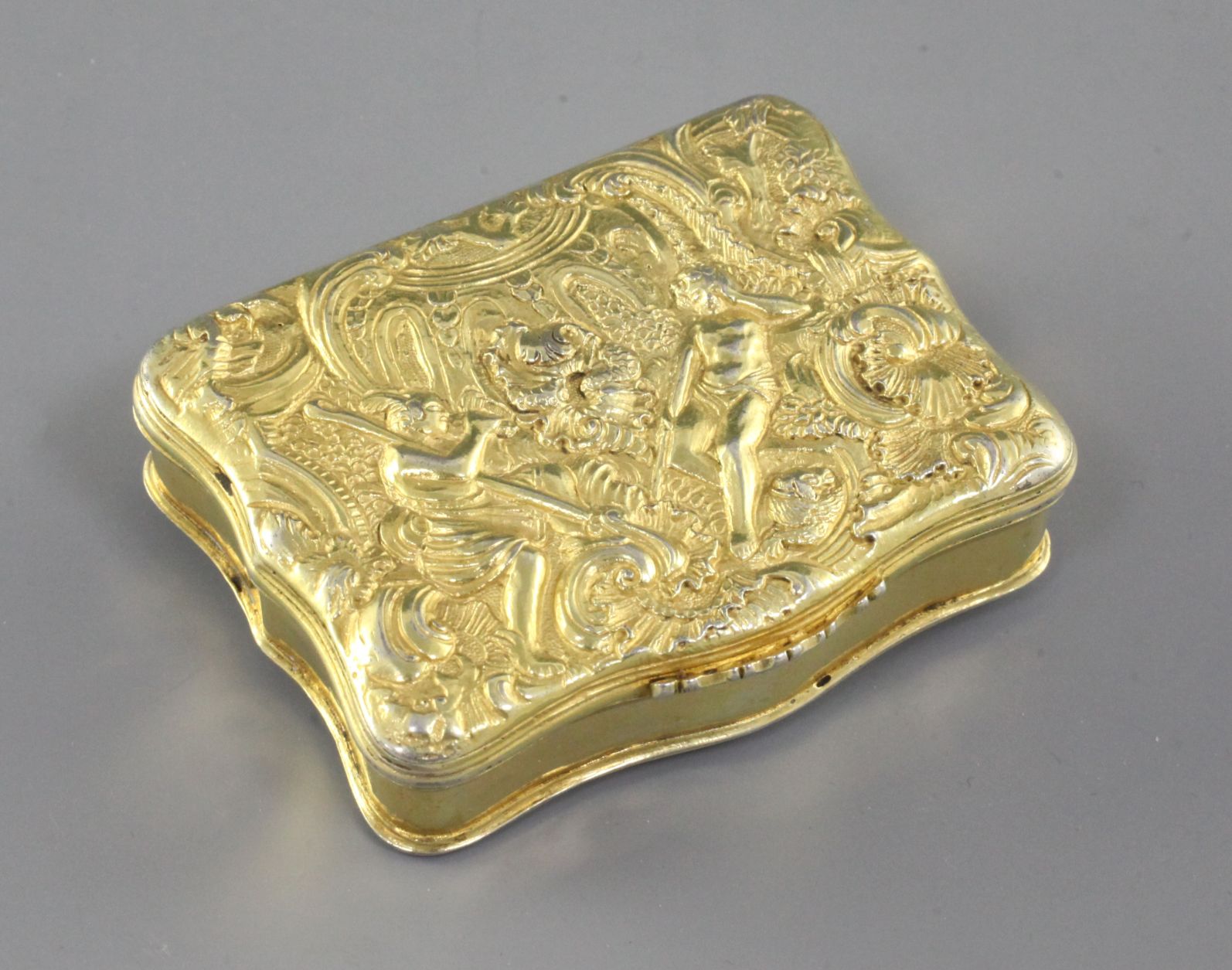 An early 19th century Scottish? silver gilt snuff box, of rectangular serpentine form, the lid