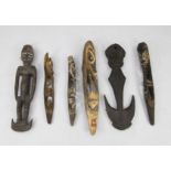 Papua New Guinea Sepik river carvings; the bench incised with masks and stylised figures, with