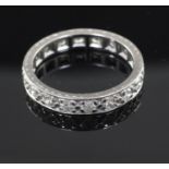 A platinum and diamond full eternity ring, set with eighteen round cut stones, size M.