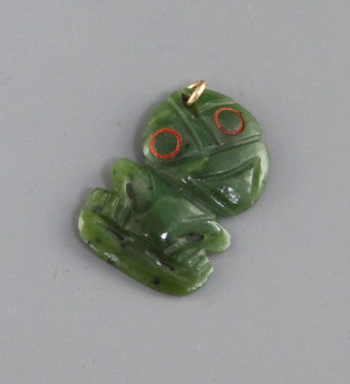 A Maori nephrite jade tiki pendant, the stylised eyes , 1.6ins