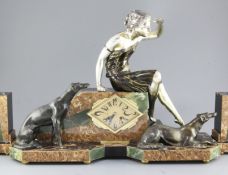 Uriano. An Art Deco bronze spelter and marble clock garniture, modelled with a woman and two borzoi,