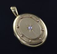 A Victorian 15ct gold and diamond set oval locket, 1.75in.