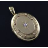 A Victorian 15ct gold and diamond set oval locket, 1.75in.