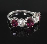 A platinum, three stone natural ruby and two stone diamond half hoop ring, with accompanying GCS