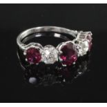 A platinum, three stone natural ruby and two stone diamond half hoop ring, with accompanying GCS