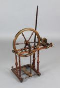 An early 19th century mahogany, oak and fruitwood spinning wheel, with bone and ivory decoration,