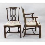 A set of twelve Chippendale style mahogany dining chairs, including two carvers, with gothic pierced