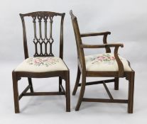 A set of twelve Chippendale style mahogany dining chairs, including two carvers, with gothic pierced