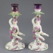 A pair of Derby 'Dry-edge' figural candlesticks, c.1753-55, each modelled as a Bacchanalian cherub