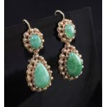 A pair of gold and jade drop earrings, each set with two cabochon stones and beaded gold border,