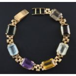 A Brazilian gold and multi gem set bracelet, mounted with seven emerald and rectangular cut stones