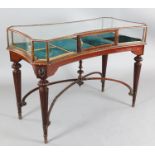 An early 20th century mahogany and satinwood display table, of concave rectangular form, on turned