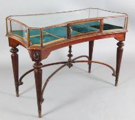 An early 20th century mahogany and satinwood display table, of concave rectangular form, on turned