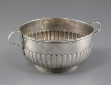 A Continental demi fluted two handled silver circular bowl, with reeded border, indistinct mark on