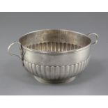 A Continental demi fluted two handled silver circular bowl, with reeded border, indistinct mark on