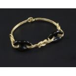 An 18ct gold and black onyx bracelet, with "knot" motifs, gross 21.8 grams.