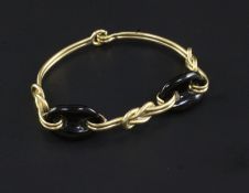 An 18ct gold and black onyx bracelet, with "knot" motifs, gross 21.8 grams.