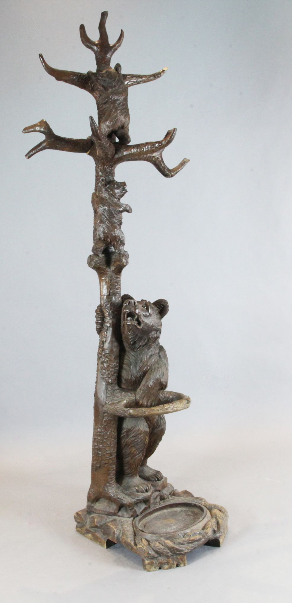 A late 19th century Black Forest carved wood bear hallstand, modelled with three bears climbing a
