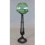 A Victorian uranium glass fish bowl on black painted wrought iron stand, H.43in.