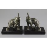 L. Carvin. A pair of Art Deco bronze bookends, modelled as elephants, with ivory tusks and signed