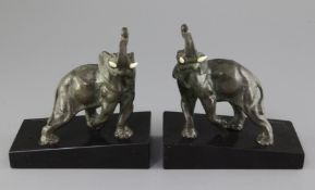 L. Carvin. A pair of Art Deco bronze bookends, modelled as elephants, with ivory tusks and signed