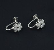 A pair of 9ct white gold and diamond cluster earrings, of flowerhead design, each set with seven