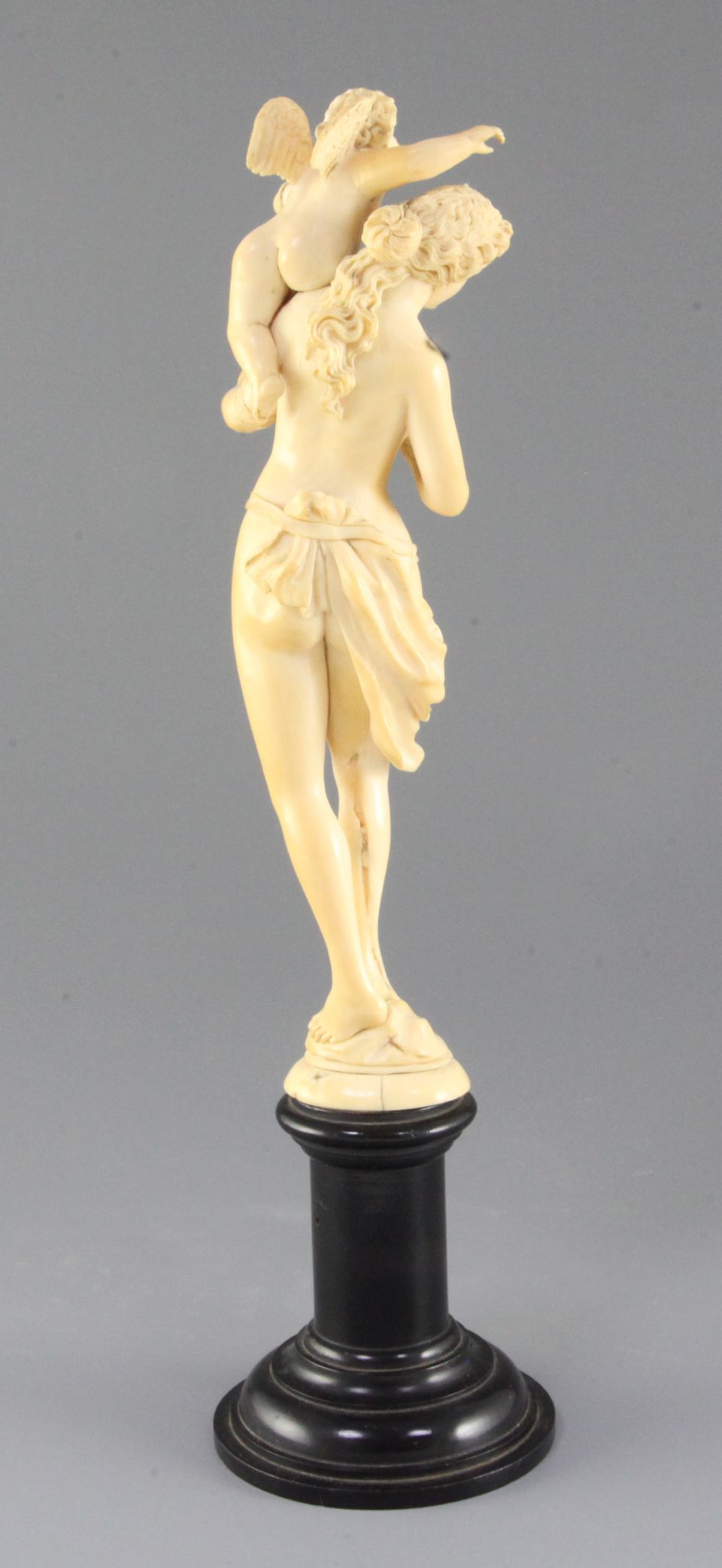 A 19th century French Dieppe ivory carving of Venus and Cupid, on an ebonised socle, Overall H.13. - Image 2 of 2